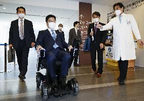 Japan health minister tries robot designed for patients