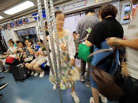 Commuters Ride at Jianguomen Subway Station in Beijing