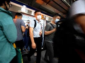 Commuters Ride at Jianguomen Subway Station in Beijing