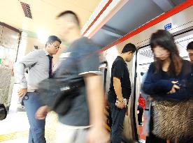 Commuters Ride at Jianguomen Subway Station in Beijing