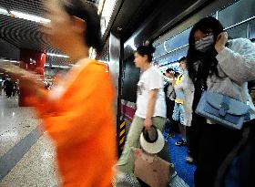 Commuters Ride at Jianguomen Subway Station in Beijing