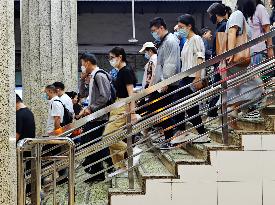 Commuters Ride at Jianguomen Subway Station in Beijing