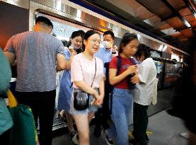 Commuters Ride at Jianguomen Subway Station in Beijing