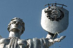 Workers Dismount A Soviet Coat Of Arms From The Shield Of The Motherland Monument In Kyiv