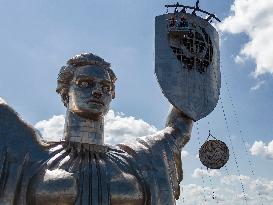 Workers Dismount A Soviet Coat Of Arms From The Shield Of The Motherland Monument In Kyiv