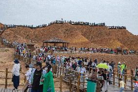 Tourists View The Danxia Landform in Zhangye, China