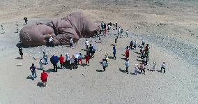 The Sculpture Son of the Earth on The Gobi Beach in Guazhou