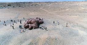 The Sculpture Son of the Earth on The Gobi Beach in Guazhou