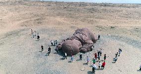 The Sculpture Son of the Earth on The Gobi Beach in Guazhou