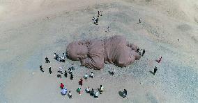 The Sculpture Son of the Earth on The Gobi Beach in Guazhou