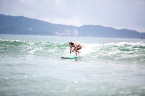 Surfers Surf at Shuangyue Bay Beach in Huizhou