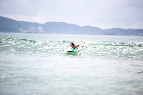 Surfers Surf at Shuangyue Bay Beach in Huizhou