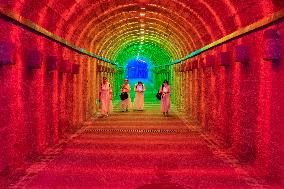 Citizens and tourists play in a converted bomb shelter in Chongqing, China, August 26, 2023. The shelter is illuminated by light