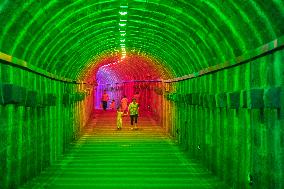Citizens and tourists play in a converted bomb shelter in Chongqing, China, August 26, 2023. The shelter is illuminated by light