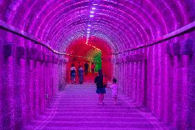 Citizens and tourists play in a converted bomb shelter in Chongqing, China, August 26, 2023. The shelter is illuminated by light