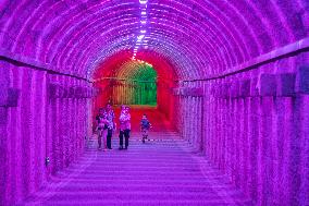 Citizens and tourists play in a converted bomb shelter in Chongqing, China, August 26, 2023. The shelter is illuminated by light