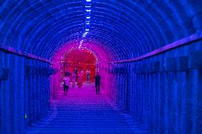 Citizens and tourists play in a converted bomb shelter in Chongqing, China, August 26, 2023. The shelter is illuminated by light