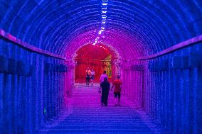 Citizens and tourists play in a converted bomb shelter in Chongqing, China, August 26, 2023. The shelter is illuminated by light