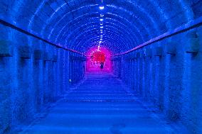 Citizens and tourists play in a converted bomb shelter in Chongqing, China, August 26, 2023. The shelter is illuminated by light