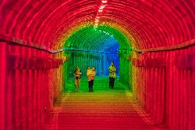 Citizens and tourists play in a converted bomb shelter in Chongqing, China, August 26, 2023. The shelter is illuminated by light