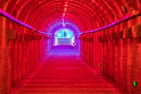 Citizens and tourists play in a converted bomb shelter in Chongqing, China, August 26, 2023. The shelter is illuminated by light