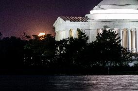 Blue supermoon rises behind Jefferson Memorial in Washington, DC, August 31