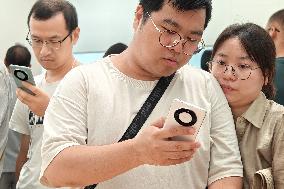 Customers Try Huawei's Mate60 Pro Mobile Phone in Shanghai