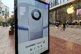 Huawei Mobile Advertising Appears in Front of The Apple Store in Shanghai