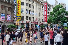Tourists Visit The Nanjing Road Walkway in Shanghai