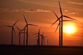 Windmills Turn As The Sun Sets At Meadow Lake Wind Farm