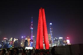 Tourists Visit The Red Landmark Monument to The People's Heroes in Shanghai, China