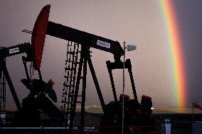 A Rainbow Appears Above An Oil Field - Calgary