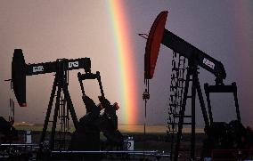 A Rainbow Appears Above An Oil Field - Calgary