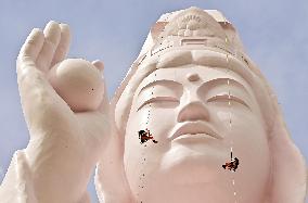 Giant Buddhist statue temporarily pink
