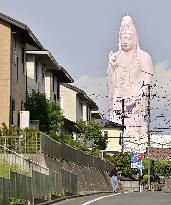 Giant Buddhist statue temporarily pink