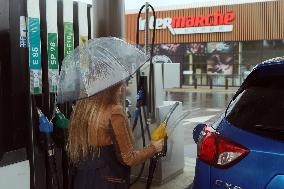 A Motorist Fills Her Car At A Petrol Station At Intermarché Hypermarket In Charité Sur Loire