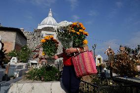 Families Visit The San Andres Mixquic Cemetery, Mexico, On The Occasion Of Saint Michael The Archangel's Day