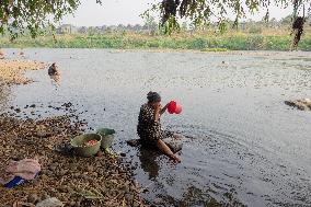 Residents Utilize River During Dry Season