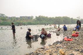 Residents Utilize River During Dry Season