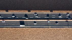 Vehicles Drive on The Hangzhou Bay Cross-Sea Bridge in Ningbo