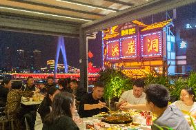 Tourists Eat at Hot Pot Restaurants in Chongqing