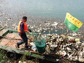 A Worker Salvages Floating Objects in the Yangtze River