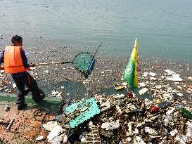 A Worker Salvages Floating Objects in the Yangtze River