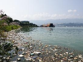 A Worker Salvages Floating Objects in the Yangtze River