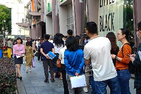 People line up outside the visa office of the U.S. consulate in Shanghai