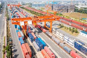 Workers Load Containers onto Vehicles in Nanjing