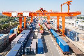 Workers Load Containers onto Vehicles in Nanjing