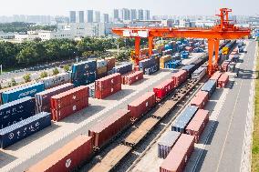 Workers Load Containers onto Vehicles in Nanjing