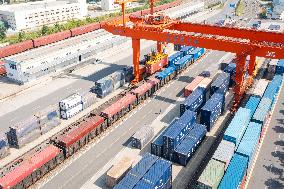 Workers Load Containers onto Vehicles in Nanjing