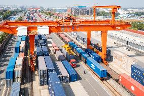 Workers Load Containers onto Vehicles in Nanjing